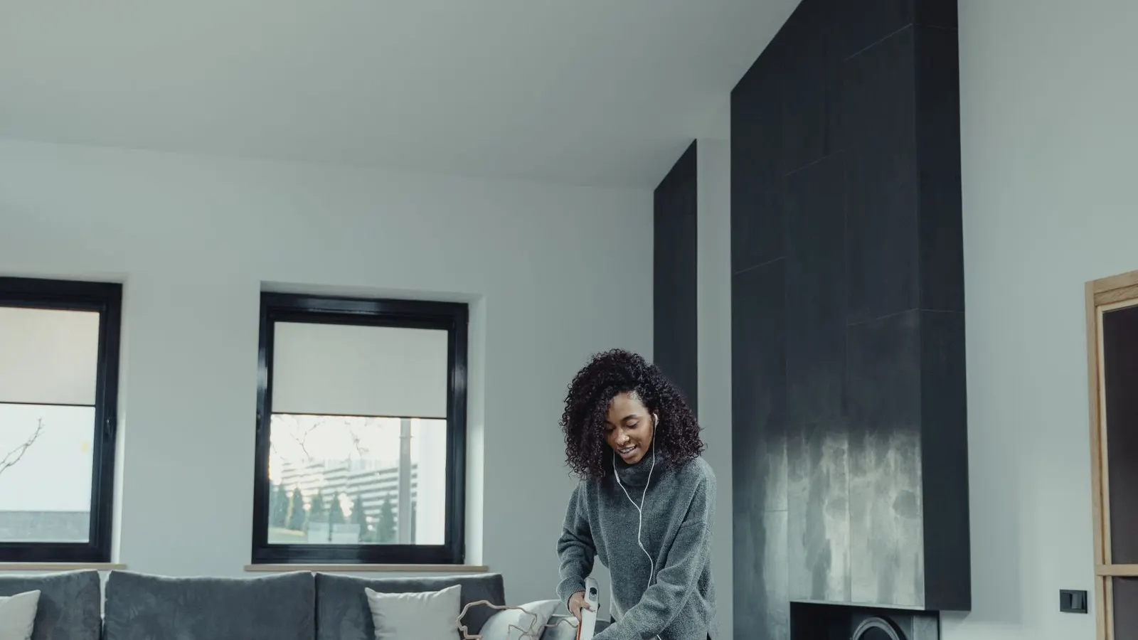 House cleaner vacuuming a bright living room, the kind of standard house cleaning BNB Home Cleaning offers in Detroit