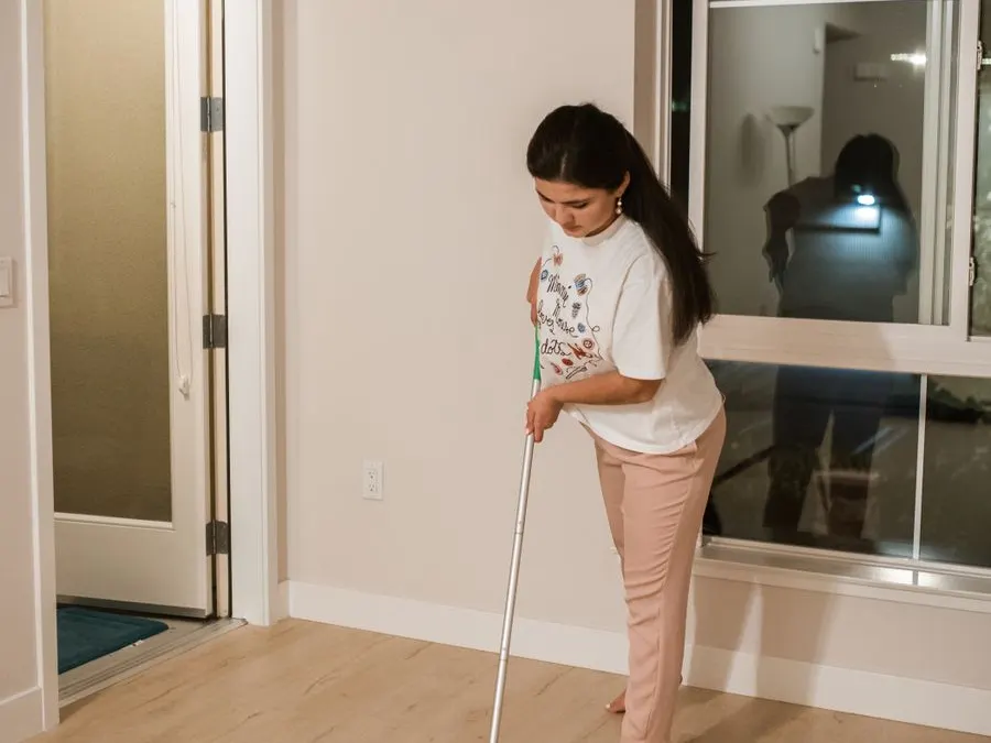 Mopping a hardwood floor during a recurring house cleaning in Metro Detroit